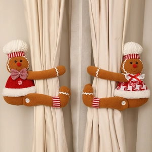 Detailed close-up of cartoon gingerbread man and woman plush Christmas curtain tiebacks