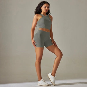 Detail of grey-green seamless knitted yoga set with high waist shorts and ribbed textures