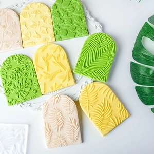 Leaf pattern fondant stamps and clay molds in green and yellow with detailed texture