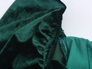 Close-up of premium green velvet fabric showing texture and smooth inner lining