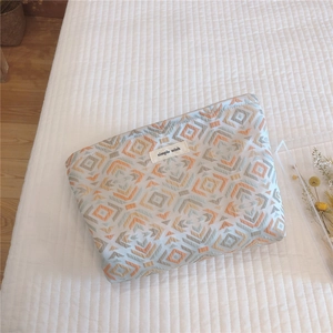 Detail of vintage geometric fabric bag with simple wish label on waffle texture