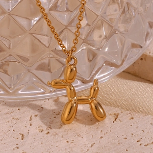 Macro view of 18K gold plated 3D balloon dog pendant on high-polish necklace chain