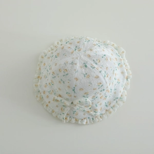 Close-up of floral baby sun hat with delicate lace texture and ruffled brim detail