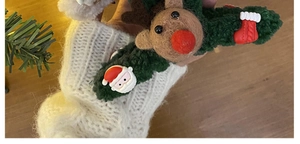 Detail of Christmas reindeer hair claw clip featuring green plush material and elk ornaments