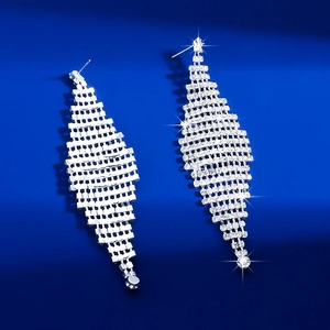 Detailed macro view of silver rhinestone long tassel earrings with geometric mesh design