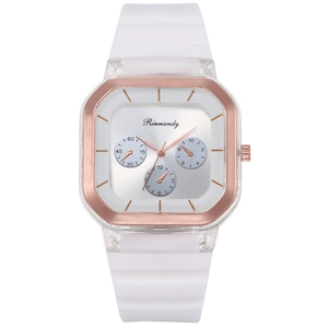 Close-up of square quartz watch featuring a rose gold frame and white silicone strap