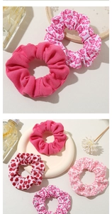 Detail of pink floral and heart pattern scrunchies with elastic knit fabric texture