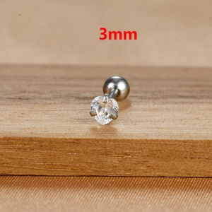 Macro shot of a 3mm heart-shaped zircon stud earring on a warm wooden background