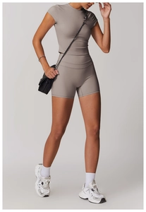 Dettaglio del set yoga tortora con crop top aderente e pantaloncini a vita alta