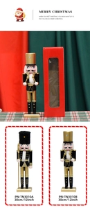 Detailed view of 30cm black and gold wooden nutcracker king in festive gift packaging