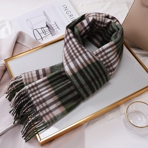 Detail of soft Australian wool plaid scarf with fringes on a golden decorative tray