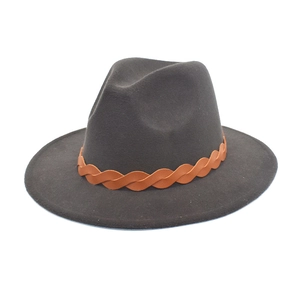 Detail of dark grey fedora hat with brown braided band on a clean white background