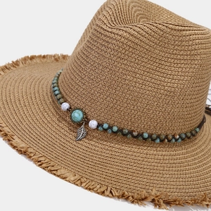 Straw sun hat with turquoise beads, metallic leaf pendant, and frayed brim detail