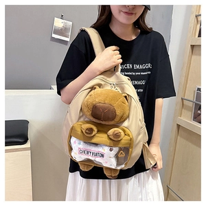 Detail of Capybara backpack featuring a plush charm and transparent front pocket