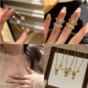 Detailed views of luxury gold and silver clover jewelry sets with white zircon accents
