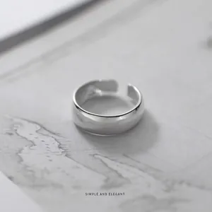 Minimalist s925 silver open ring with a polished mirror finish on vintage background