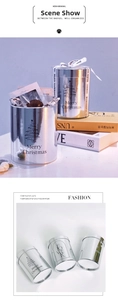 Detailed view of silver metallic cylindrical Christmas flower boxes with snowflake patterns