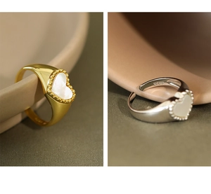 Detail of S925 sterling silver heart rings with white mother of pearl in gold and silver