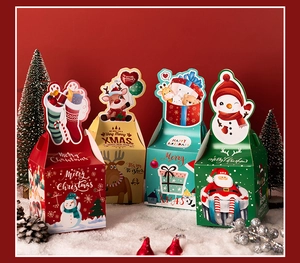 Detailed view of four colorful Christmas gift boxes on snow background with festive decor