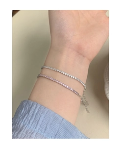 Detailed macro view of S925 sterling silver tennis bracelets in silver and pink with extension chain