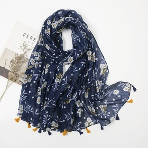 Detailed view of dark blue floral cotton linen scarf featuring soft yellow tassels