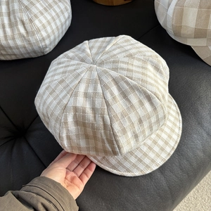 Detailed top view showing the eight-panel structure and plaid texture of the linen baker boy hat