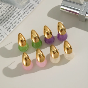 Close-up of teardrop earrings in gold metal and resin in green, purple, pink and white