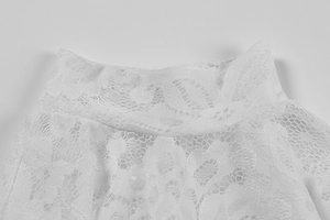 Detail of white lace dress featuring high neck floral hollow crochet and mesh textures
