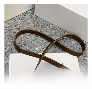 Detail of adjustable dark brown leather shoulder strap with matte finish and neat stitching