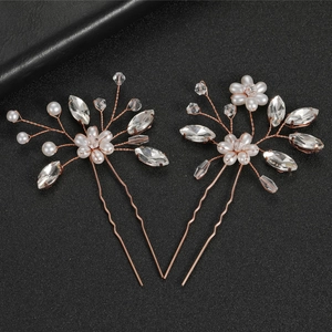 Detailed close-up of handmade gold wire hair pins with white pearls and clear crystals