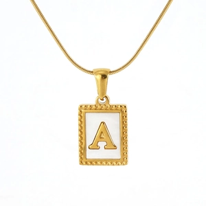Detail of gold square pendant with white mother of pearl and letter A on snake chain