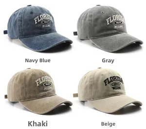 Detail view of vintage cotton baseball caps in navy, grey, khaki, and beige colors