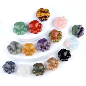 Natural crystal cat paw carvings in amethyst, tiger eye, and rose quartz on a white stand