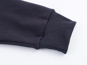 Detail of dark blue ribbed knit cuffs showing high-quality fabric texture and stitching
