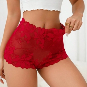Close-up of red floral lace panties showing intricate hollow texture and scalloped edges