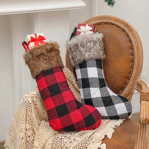 Classic red and white plaid Christmas stockings with plush faux fur trim on a vintage chair