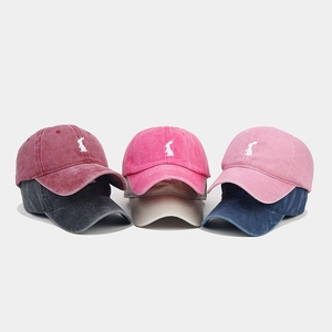 Detail of six vintage washed cotton baseball caps with rabbit embroidery in multiple colors
