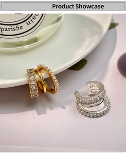 Detailed close-up of triple-layered pearl and zircon ear cuffs in gold and silver