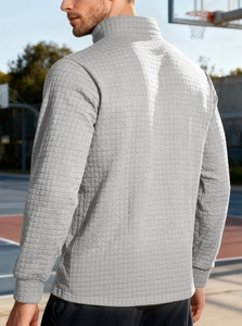Detail of light grey waffle knit fabric and casual cut on men's half-zip sweatshirt