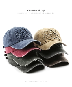 Detail view of multi-colored washed cotton baseball caps with New York embroidery