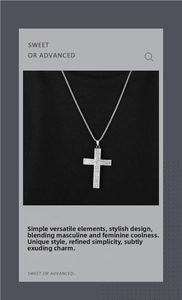 Macro shot of silver cross pendant with sparkling crystals on a textured black surface