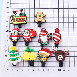 Cartoon Christmas Santa and elk PVC hair clips set displayed on measurement mat
