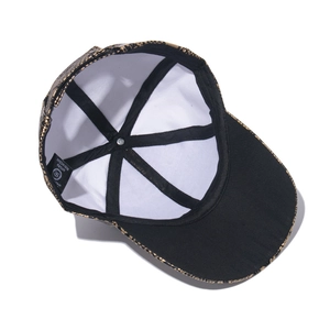 Detail shot of black snake pattern PU baseball cap showing inner lining and material label