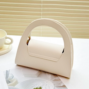 Elegant off-white leather handbag with top handle and gold chain strap in minimalist style