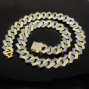 Detail of 15mm hip hop cuban chain featuring clear and blue rhinestones on gold links
