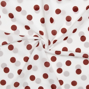 Detailed view showing the soft texture and wine red polka dots on white dress fabric