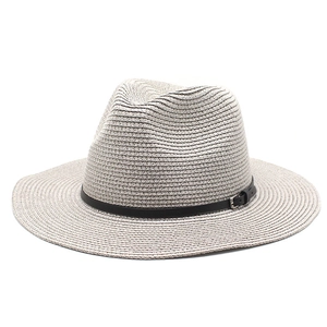 Close-up of woven straw fedora featuring a black leather band and metal buckle detail