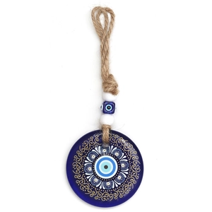 Close-up of blue glass evil eye pendant with rustic jute rope and decorative beads