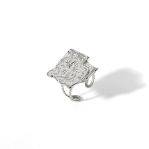 Top view of adjustable silver ring with irregular molten lava texture and bead accents
