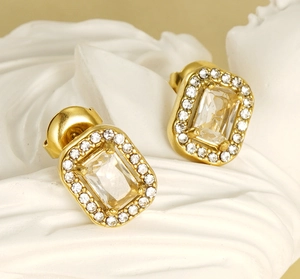 Detail of gold double-layer earrings with emerald-cut zirconia and pave setting